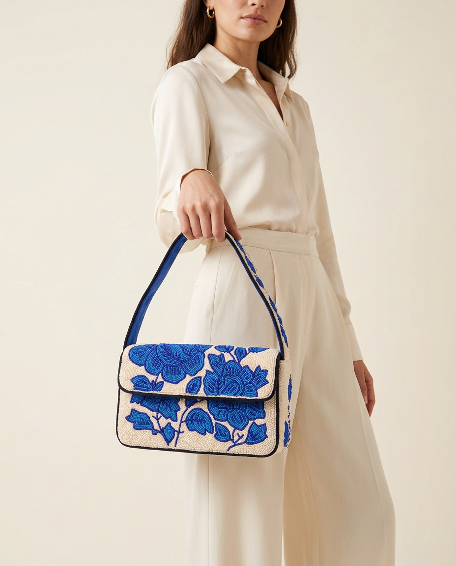 The Azure Bloom worn with a neutral outfit, its blue floral beadwork and cobalt strap fully visible